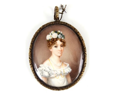 A 19th CENTURY PORTRAIT MINIATURE ON IVORY of a young lady with flowers in her hair in cased gold metal frame, blue enamelled