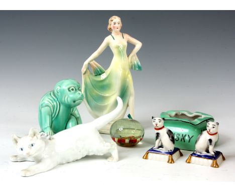 A SELECTION OF ITEMS to include a Meissen cat, a pair of continental porcelain cats sat on cushions, an advertising ashtray f