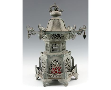 A MEIJI PERIOD JAPANESE LANTERN with pagoda top and elephant head finials above a pierced body on bracket feet 50cm high.