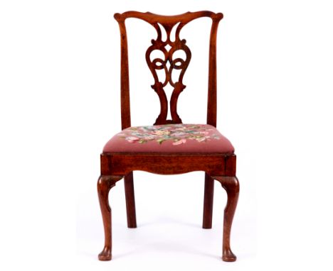 A GEORGE I WALNUT SIDE CHAIR with vase shaped pierced back, drop in tapestry seat and standing on cabriole legs and pad feet 