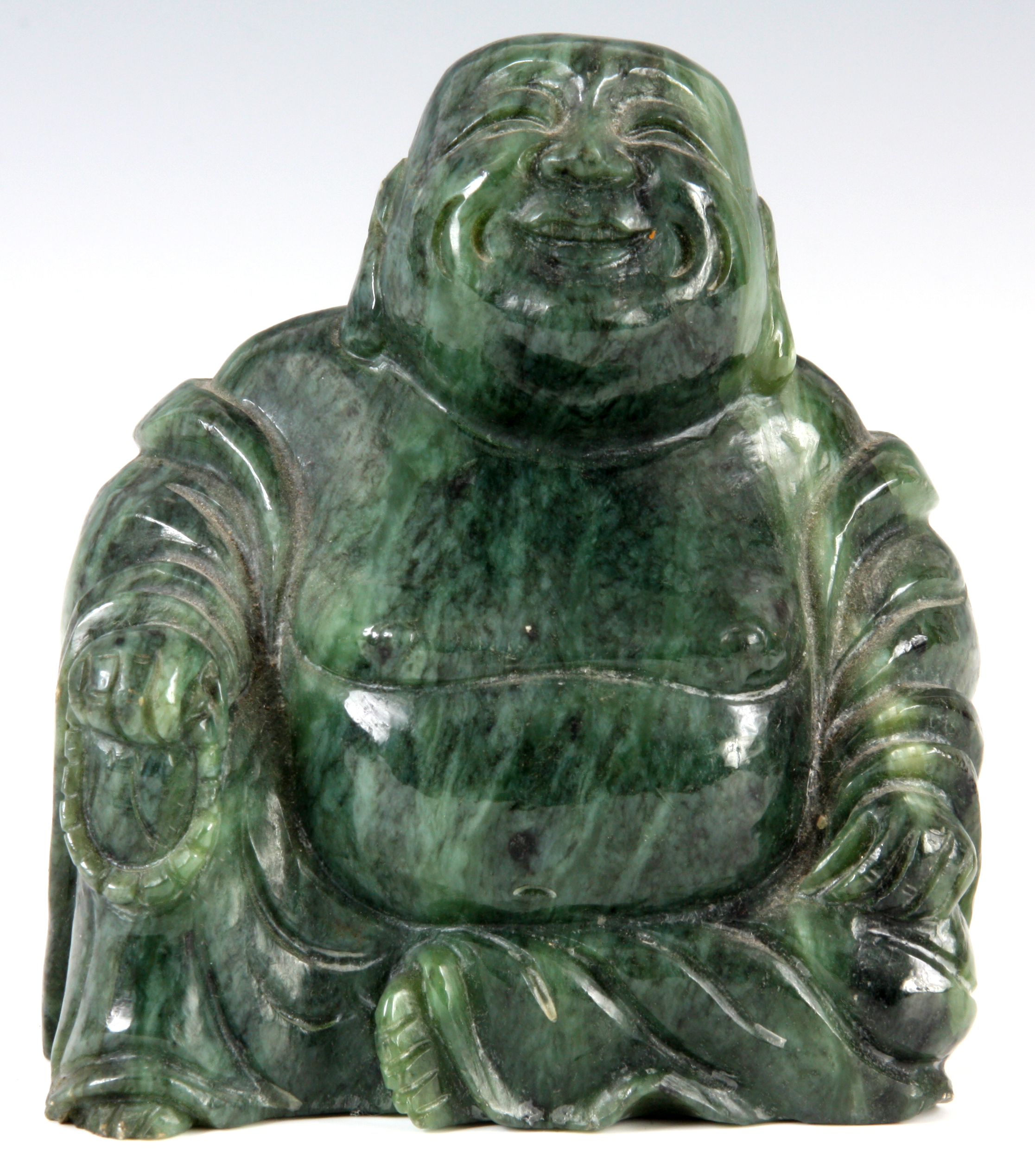 A GREEN MARBLE SCULPTURE of a seated Buddha 11cm high.