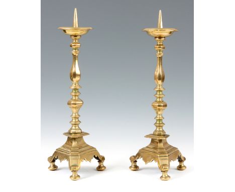 A PAIR OF 18TH CENTURY DUTCH PRICKET STICK CANDLESTICKS with dished drip trays above chamfered baluster turned stems and trif