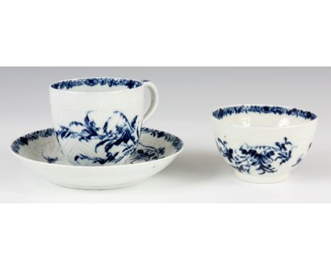 AN 18TH CENTURY BLUE AND WHITE FIRST PERIOD WORCESTER TRIO comprising of a teacup &amp; saucer and a tea bowl, decorated in l