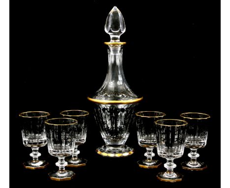 A CONTINENTAL GILT AND BLACK PAINTED DECANTER AND SIX MATCHING GOBLETS of facetted from 34cm and 11cm high.