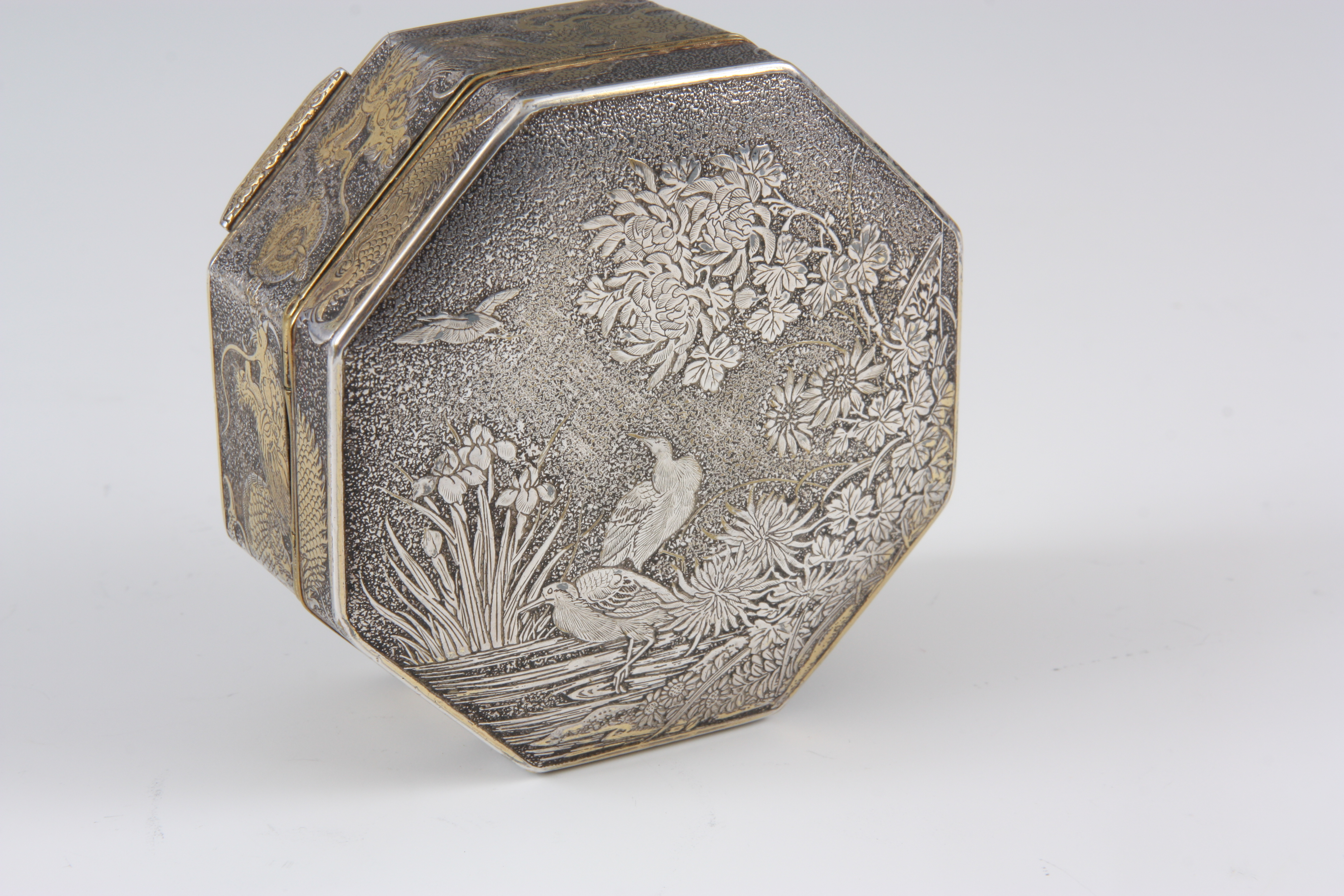 A LATE 19TH CENTURY SILVERED BRASS JAPANESE OCTAGONAL BOX with a lift ...