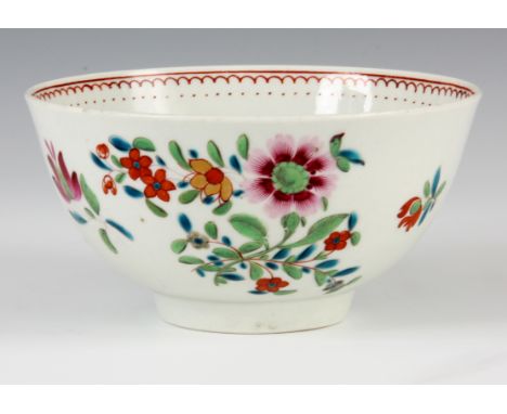 AN 18TH CENTURY POLYCHROME FIRST PERIOD WORCESTER BOWL decorated with flowers 6.5cm high 12cm diameter.