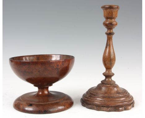 A 19th CENTURY TREEN FRUITWOOD GOBLET on turned circular foot 14cm diameter 10cm high, and a walnut candlestick with turned w