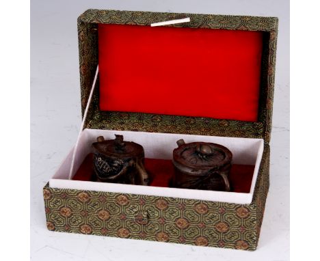 TWO JAPANESE CERAMIC MINIATURE TEAPOTS formed as realistic moulded pieces of bamboo with a beetle and squirrel to each; in a 