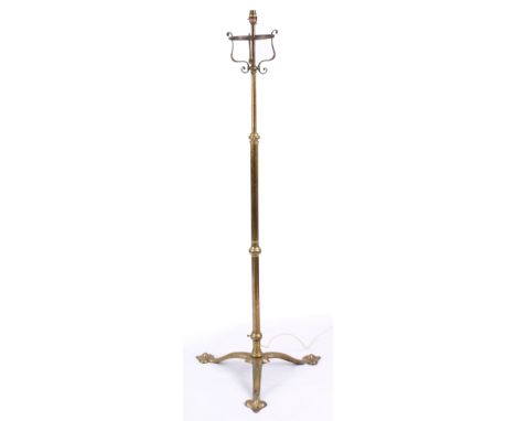 AN EARLY 19TH CENTURY ART NOUVEAU HAMMERED BRASS TELESCOPIC STANDARD LAMP with a tapering stem, standing on a stylised tripod