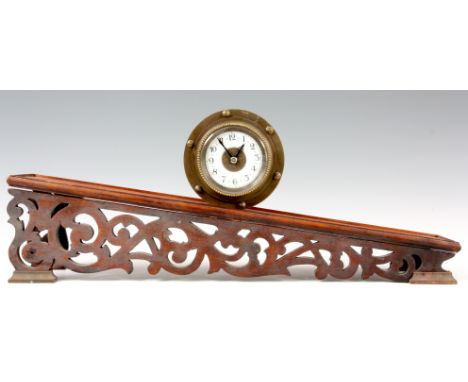 AN EIGHT DAY BRASS CASED INCLINE GRAVITY CLOCK with drum shaped case enclosing a porcelain dial with Arabic numerals fronting