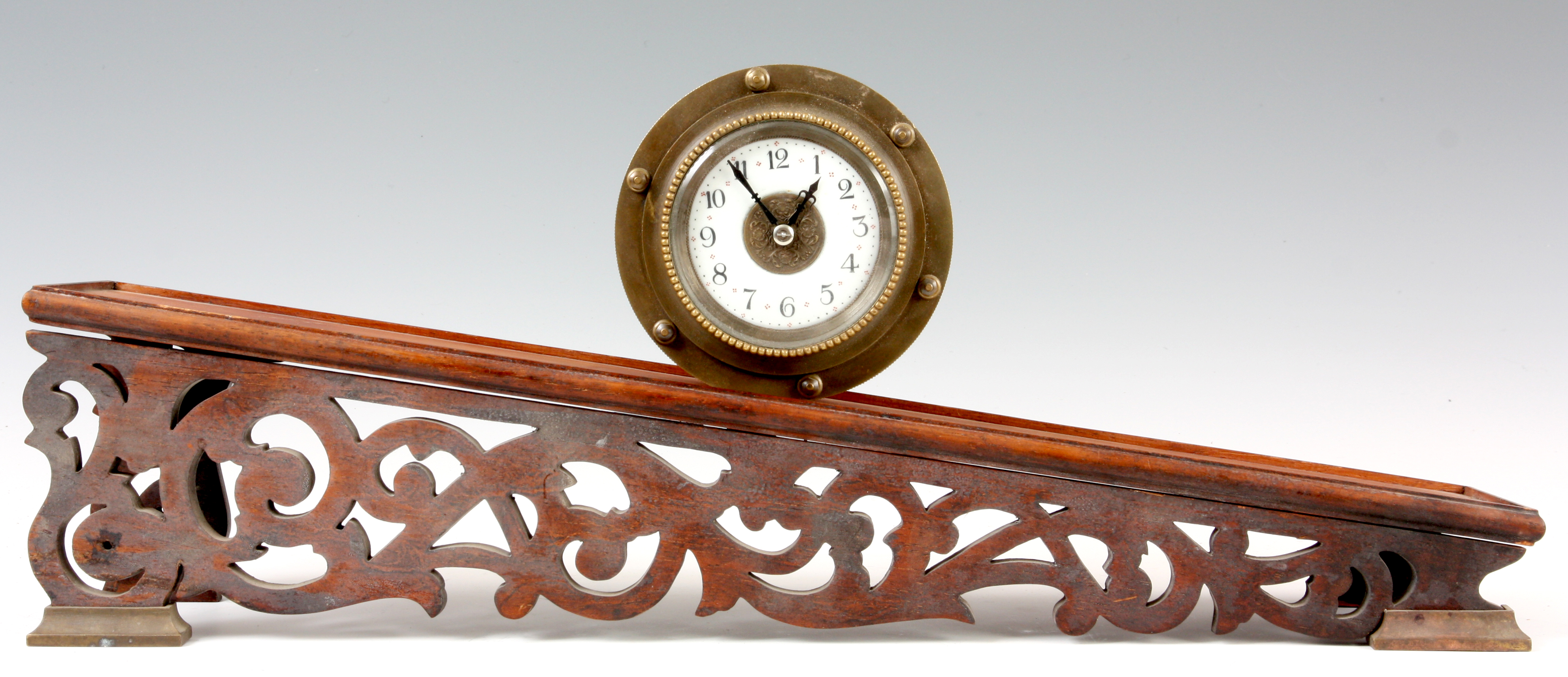 AN EIGHT DAY BRASS CASED INCLINE GRAVITY CLOCK with drum shaped case