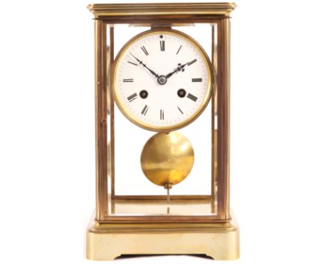 A 19TH CENTURY FRENCH FOUR GLASS BRASS MANTEL CLOCK with porcelain dial, Roman hour and Arabic minute markings fronting a sus