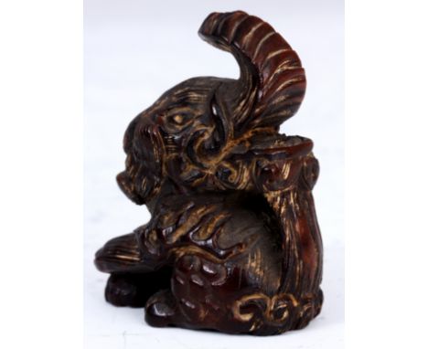 A JAPANESE HARDWOOD NETSUKE of Baku, signature to underside.