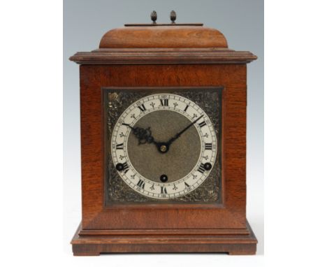 A MID 20th CENTURY WALNUT CASED BRACKET CLOCK with caddy top pediment below a square glazed door enclosing a brass dial with 