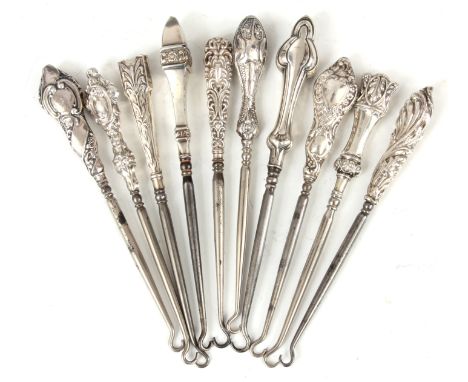 A COLLECTION OF TEN EDWARDIAN STERLING SILVER HANDLED BUTTON HOOKS with embossed&nbsp;tops - hallmarked 19cm and smaller.&nbs