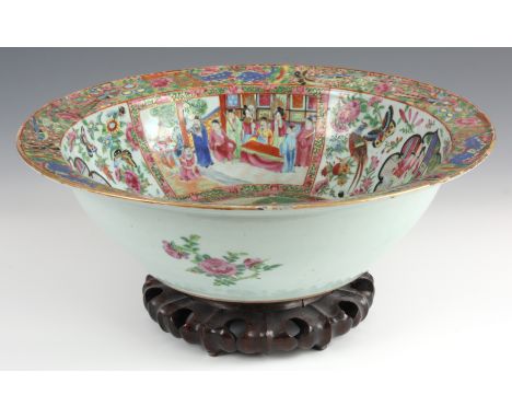 A LARGE 19TH CENTURY CANTON BASIN ON STAND decorated panelled town scenes and floral decoration 12cm high 42cm diameter.