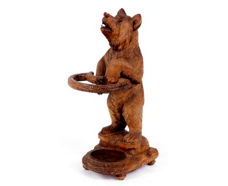 A LATE 19TH CENTURY SWISS CARVED WALNUT BLACK FOREST BEAR CUB STICK STAND depicting a finely carved standing bear with glass 