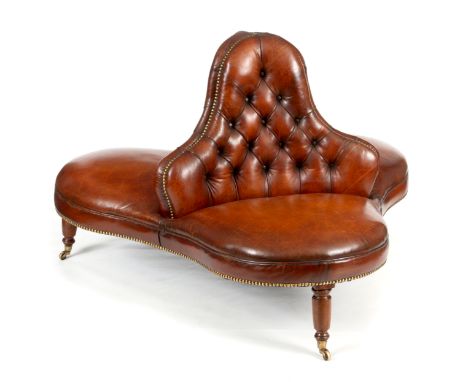 A 19TH CENTURY BROWN LEATHER CONVERSATION SEAT with shaped button back and brass stud edges; standing on mahogany turned legs