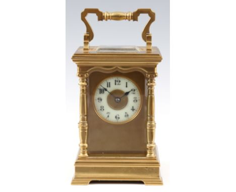A LATE 19th CENTURY GILT BRASS STRIKING CARRIAGE CLOCK with four baluster pillars on a stepped base and hinged handle enclosi