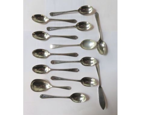 A silver caddy spoon; a silver butter knife; a matched set of ten silver tea spoons with crossed gold club motifs; and a sing