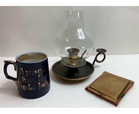A gilt metal ladies compact in pouch, a small German mug and a chamber candlestick with glass shade
