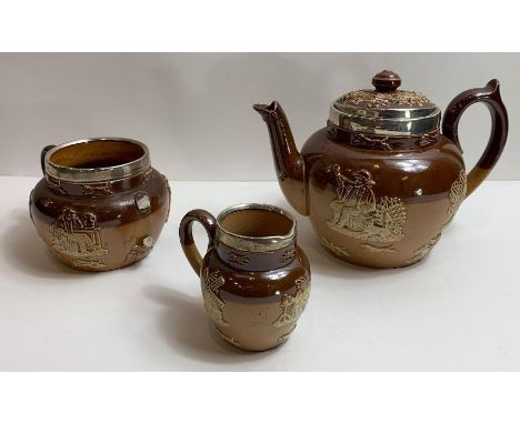 A Doulton Lambeth stoneware tea set comprising teapot, milk jug and sugar, with typical applied decoration of topers, hounds 