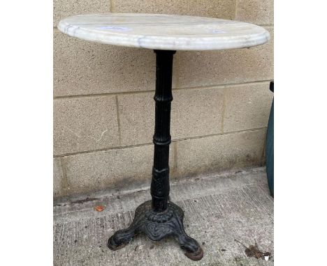 A marble topped garden table, standing on an iron tripod base, 71cm high, 48cm diameter 