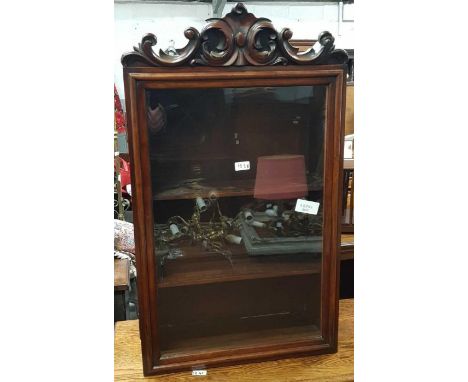 A Victorian mahogany hanging cupboard, with a single glazed door and carved finial, 94cm high, 56cm long, 23cm deep ## KEY ##