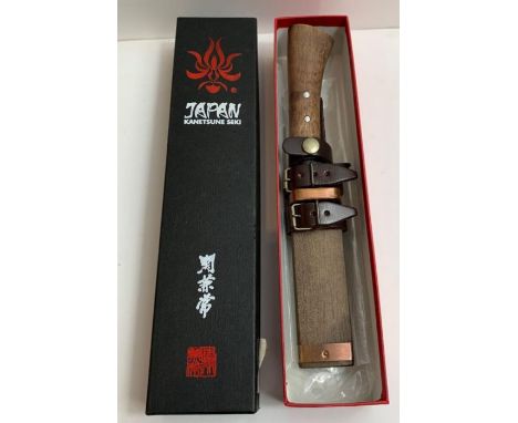 A modern Japanese dagger, Kanetsune, having wood grip and in wood scabbard with leather belt loop, in original box