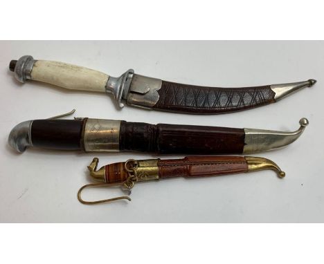 A Scandinavian hunting knife in leather scabbard, overall 21cms long; a small Finnish knife in leather certificate, and anoth