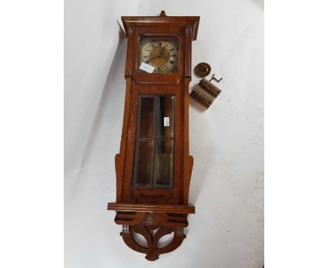 An early 20th century light oak cased wall clock, the brass dial inscribed M S Jamieson Kilmarnock, with an unusual engraved 