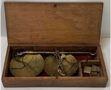 A set of apothecary's scales with weights in wood case