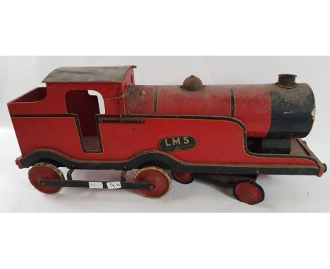 A vintage LMS model of a locomotive, the wooden frame painted in red and back, on moving wheels, 85.5cm long