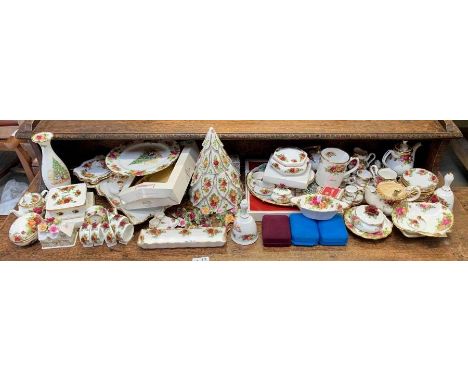 A collection of Royal Albert Old Country Roses to include Christmas examples, miniature teapots, napkin rings, clock and othe