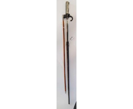 A Worcestershire Regiment swagger stick 66cms long together with a French bayonet with triform blade in metal scabbard, blade