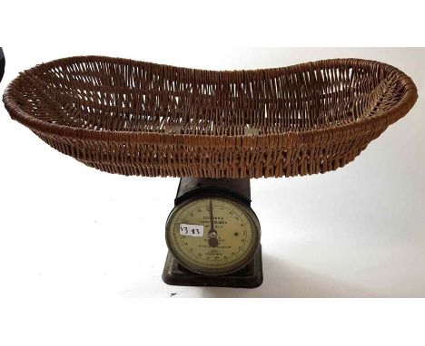 A set of Hughes's baby weighing scales, painted black base, and fitted wicker basket 