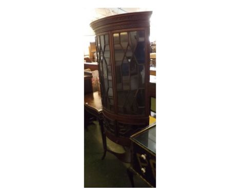 Early 20th century mahogany full length corner cabinet of bow fronted form, having two long and two short astragal glazed doo