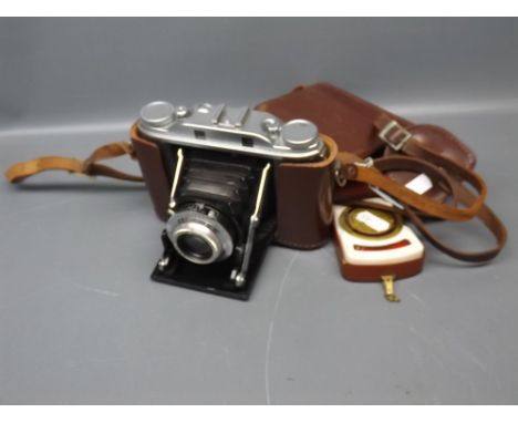 Leather cased Agfa Isolette compact German camera, together with a further Zeiss Akon light meter and further lens case