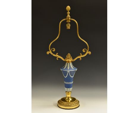 A 19th century gilt-metal mounted jasperware table lamp, the urn sprigged in the Neoclassical taste with ram's head bosses an