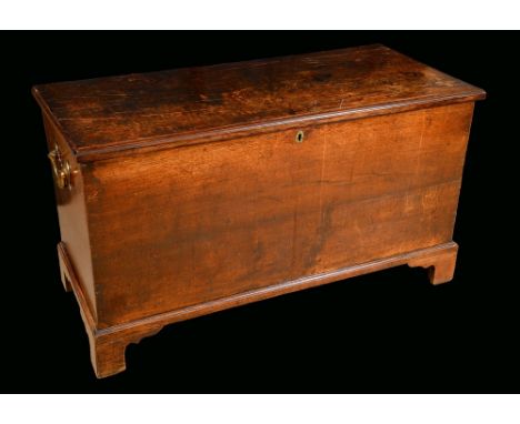 An 18th century oak blanket chest, hinged top, bracket feet, substantial brass bat shaped carrying handles to sides, 71cm hig
