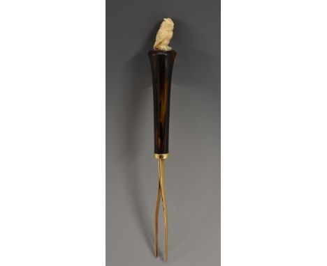 A pair of 19th century gold coloured metal novelty tweezers, the tortoiseshell haft with owl finial, 12cm long, c.1890
