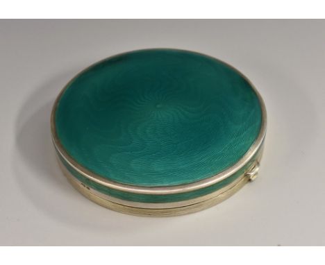 An Art Deco silver and enamel circular powder box, hinged cover engine turned and decorated in tones of emerald green 6.5cm d