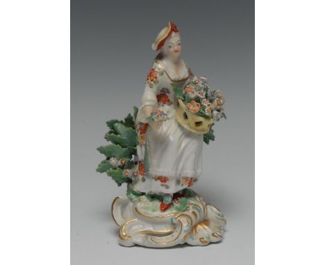 A Derby Patch Mark figure, Allegorical of Spring, seated holding a basket of flowers, before bocage, pierced scroll base, 14c