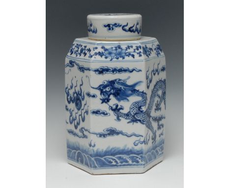 A 19th century Chinese porcelain hexagonal ginger and cover, painted in underglaze with a ferocious dragon in pursuit of a fl