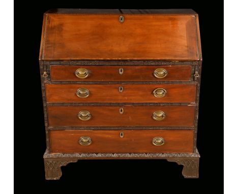 A George III mahogany bureau, fall front enclosing a cupboard, pigeon holes, small drawers, secret compartments, above four l