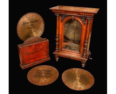 A 19th century coin operated penny-in-the-slot walnut polyphon, by Nicole Freres, Leipzig, the vertical mechanism playing 49c