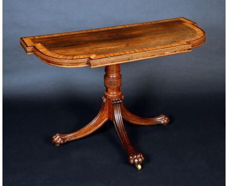 An unusual Regency satinwood crossbanded rosewood card table, folding top enclosing an inset baize lined playing surface, tur