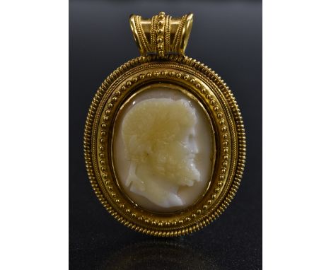A 19th century carved onyx cameo portrait pendant, Zeus with wreath and beard, yellow metal beaded frame, owl purity marks, 4