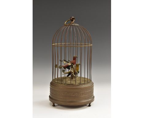 An automaton, as a pair of songbirds in a brass cage, clockwork mechanism, ring finial, 28cm high
