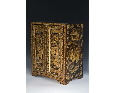 A Chinese lacquer table cabinet, flush top above a pair of rectangular raised panelled doors enclosing five collector's drawe